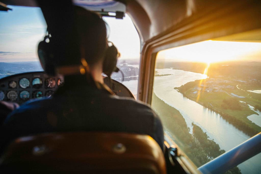 Aviation student studying EASA exam materials in cockpit